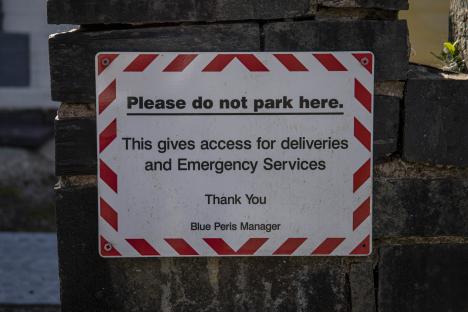 No parking sign for deliveries and emergency services.