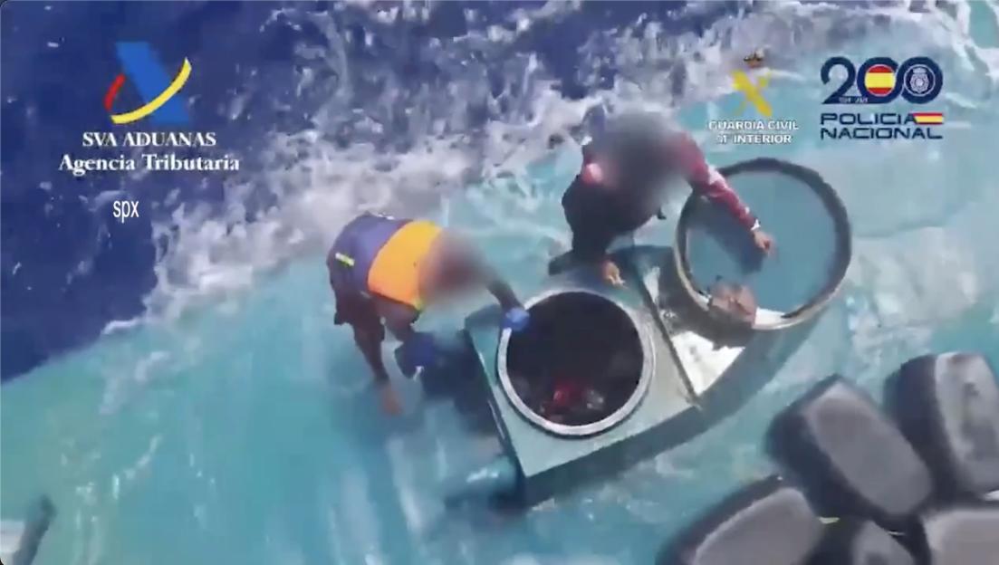 Spanish authorities arresting the crew of a narco-submarine.