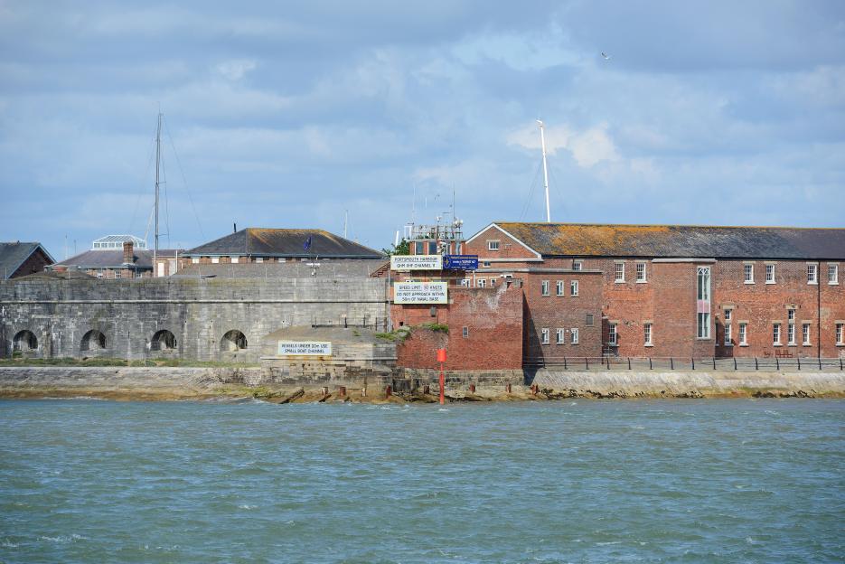 Fort Blockhouse, Portsmouth Harbour, with a red buoy and signs about speed limits and channels.