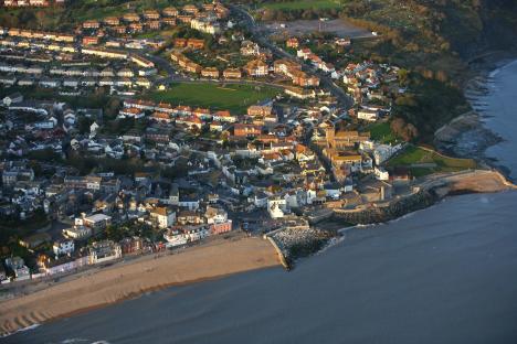 Aerial view of Lyme Regis, Devon, England, showing the town, beach, and coastline.