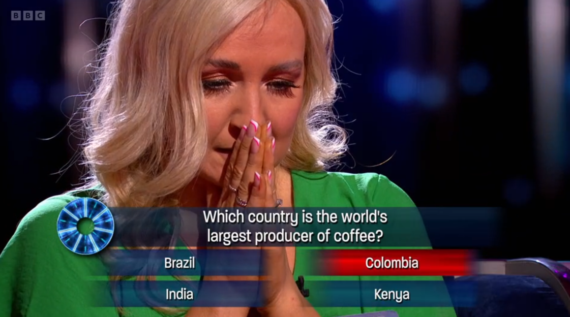 Contestant crying while answering a question about the world's largest coffee producer.