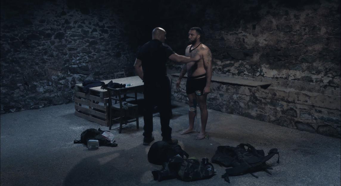 A man being interrogated in a dark room.