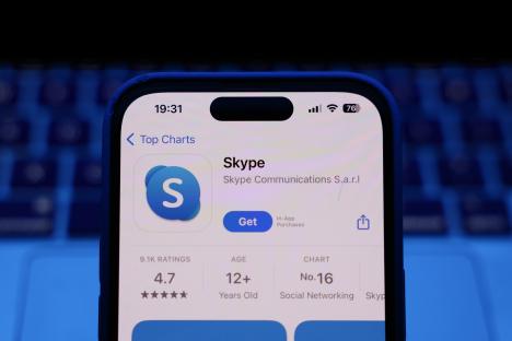 Illustration of a phone displaying the Skype app store page.
