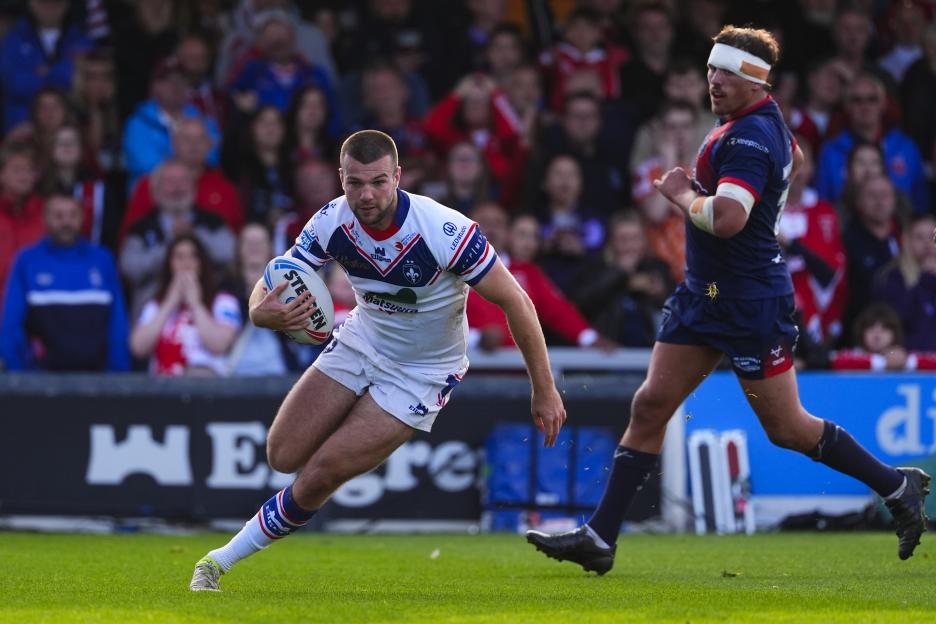 Max Jowitt of Wakefield Trinity with the ball, running past a Hull KR player.