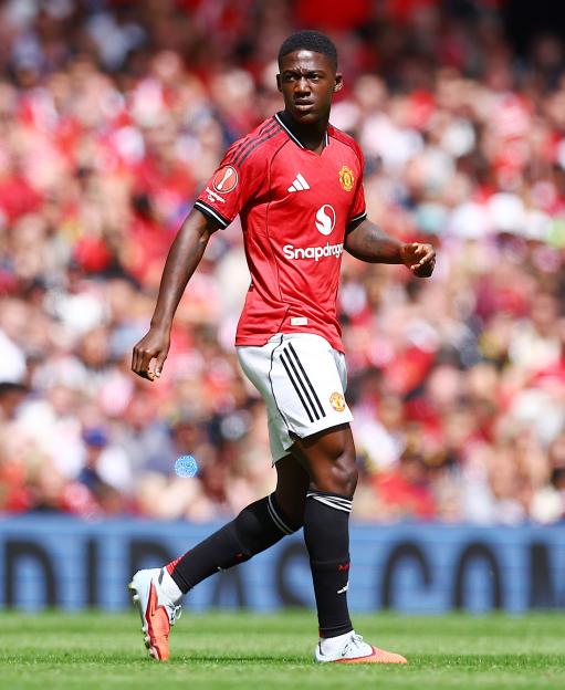 Kobbie Mainoo of Manchester United playing football at Old Trafford.