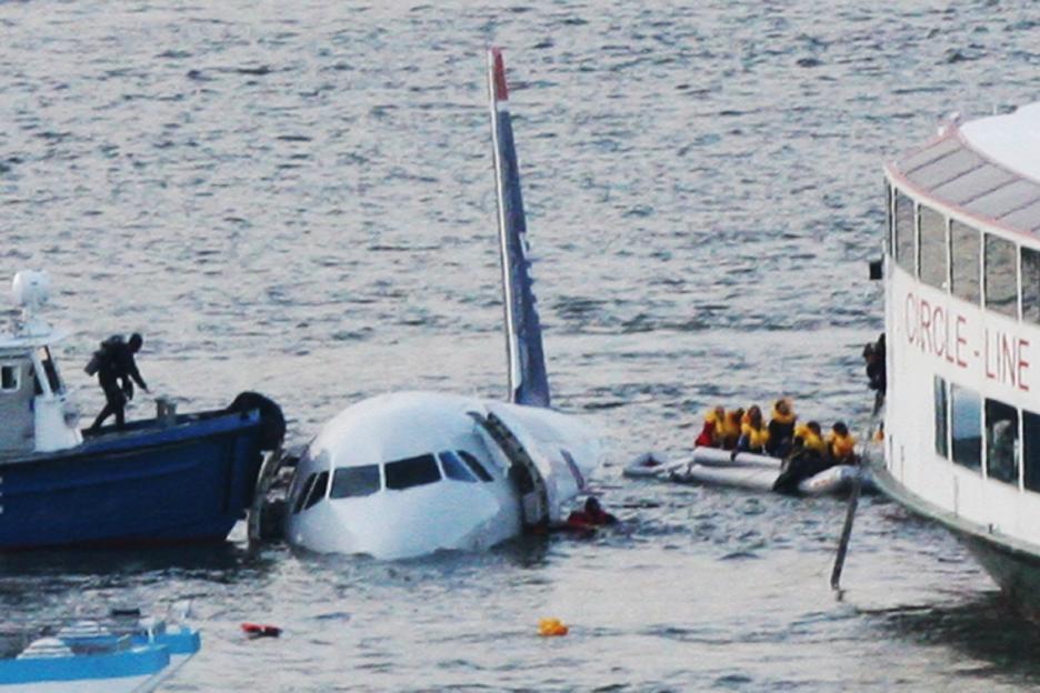 Passengers evacuate a US Airways Airbus 320 jetliner that safely ditched in the Hudson River.