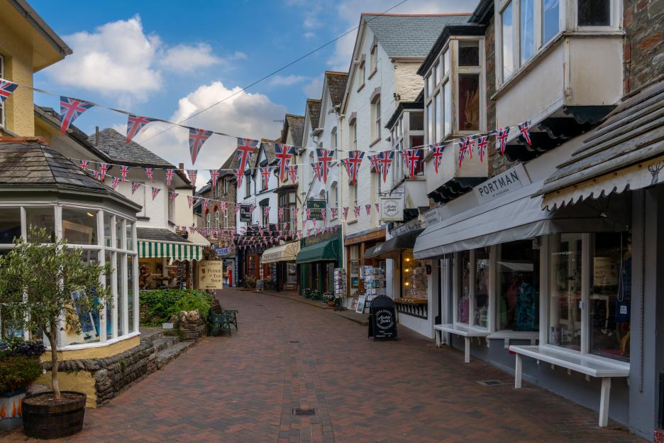 Lynmouth village center with colorful shops and Union Jack bunting.