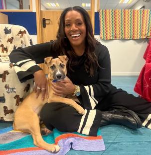 Alison Hammond holding a tan puppy.
