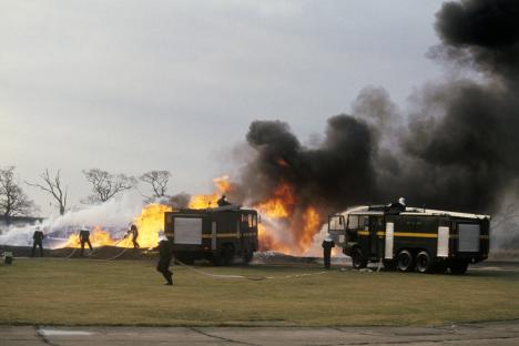 Firefighters extinguishing a large fire.