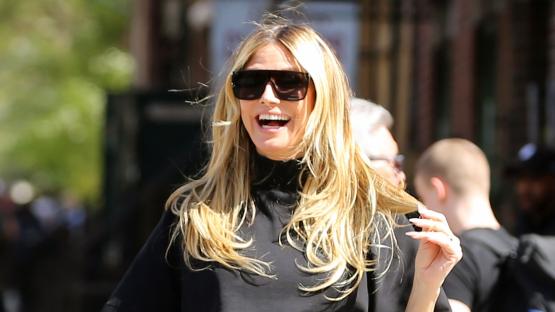 Heidi Klum shows off long legs in tiny leather miniskirt and high heels while running around NYC