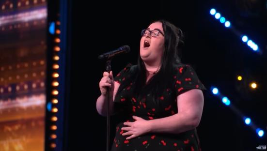Singer performing on stage.