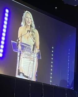 Woman giving a speech at a podium.