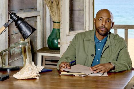 A man reviewing paperwork at a desk.