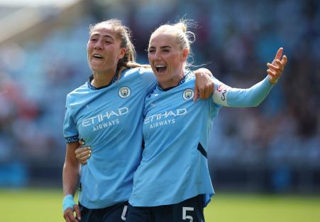 Manchester City's Laia Aleixandri and Alex Greenwood celebrating.