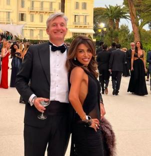 A man and woman in formal attire at an outdoor event.