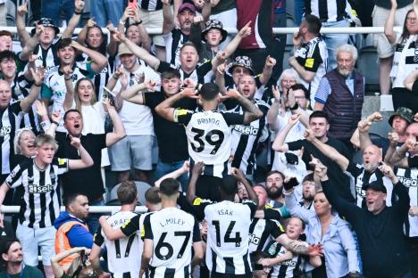 Newcastle United's Bruno Guimarães celebrates a goal with fans.