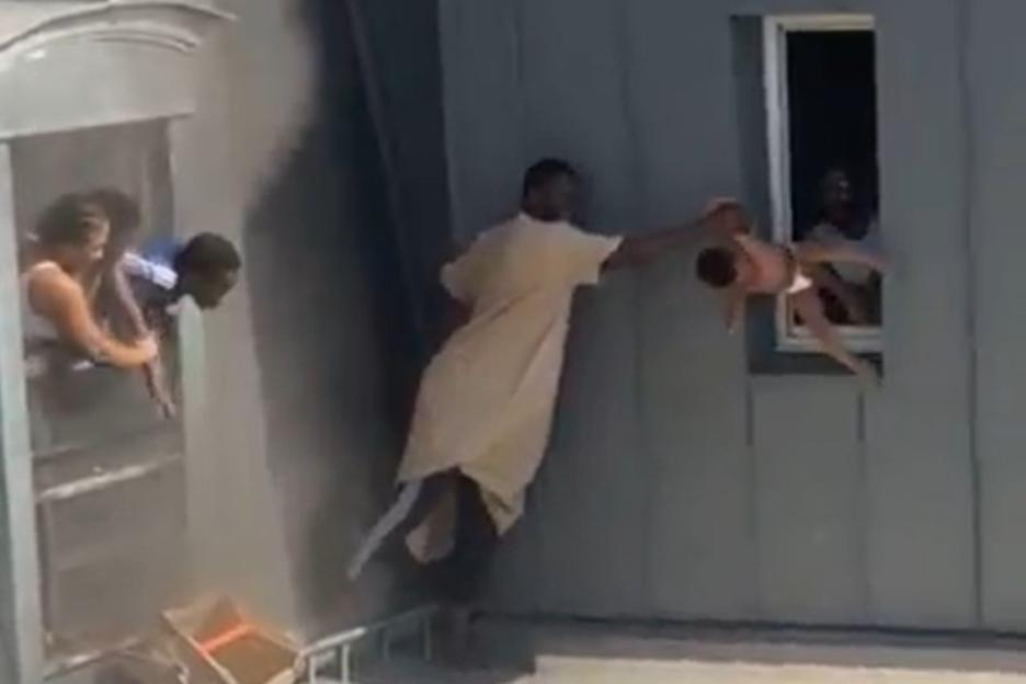 Dramatic moment hero caretaker rescues four babies from 6th-floor burning flat in Paris as he balances on narrow ledge