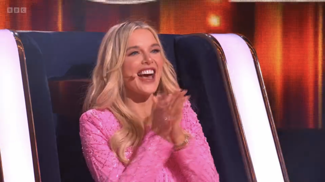 Woman in pink dress clapping.