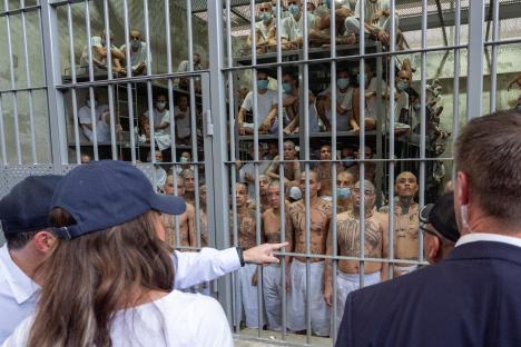 Prisoners in a cell block are viewed by officials.