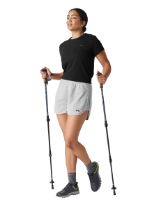 Woman hiking with trekking poles.