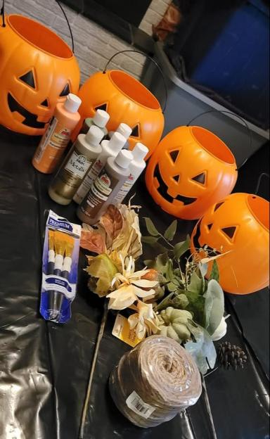 Supplies for decorating plastic pumpkin containers.