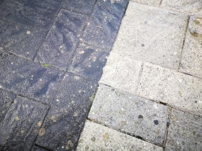 Close up of before and after patio cleaning with high pressure water jet wash. Full frame - background with copy space.