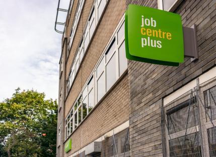 Job Centre Plus sign on a brick building.
