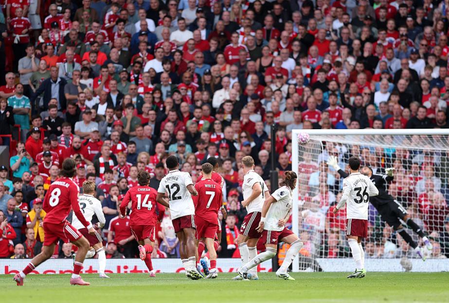 Liverpool's Szoboszlai scoring a free kick against Arsenal.