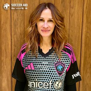 Julia Roberts wearing a Soccer Aid jersey.