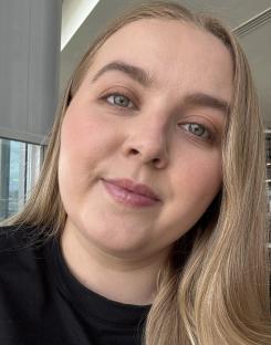 Close-up selfie of a woman with long blonde hair.