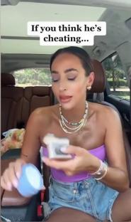 Woman in car holding small box, suggesting infidelity.