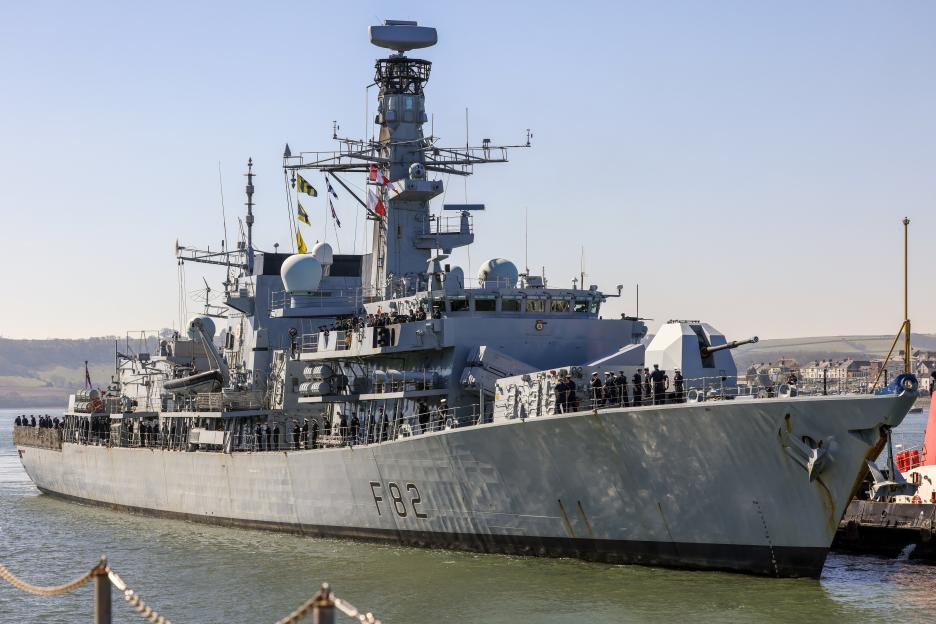 HMS Somerset, a Plymouth-based frigate, with sailors lined up on deck.