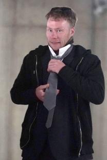Adam Carruthers adjusting his tie at Newcastle Crown Court.