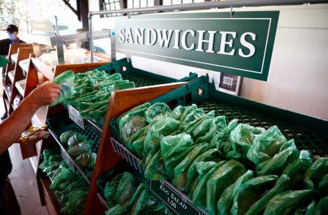 Sandwiches in plastic bags at a concession stand.