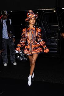 Tyla on the Upper East Side wearing a striped orange and brown outfit.