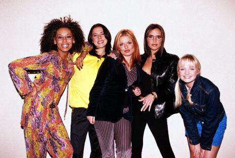 Four girl band members posing on stage.