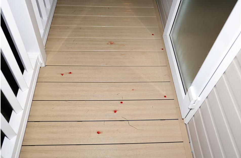Crime scene photo showing blood drops on the floor of a caravan.