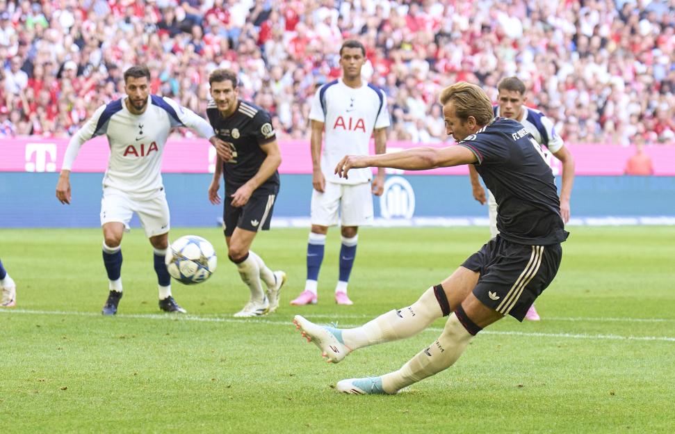 Harry Kane taking a penalty kick during a soccer match.