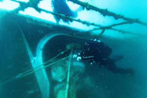 Divers exploring the sunken Bayesian yacht.