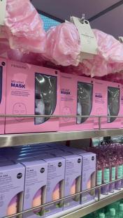 Primark LED light masks and shower caps on display.
