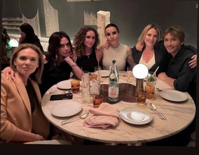 Victoria Beckham dining with friends.