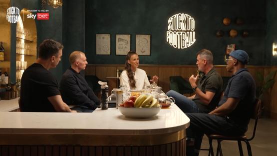Four people sitting at a bar, talking.