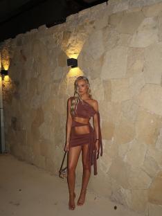 Woman in brown cutout dress.