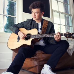 Mark Bontempo playing an acoustic guitar.