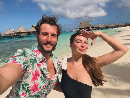 Couple taking a selfie on a tropical beach.