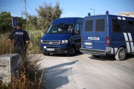 Police vans at a roadblock.