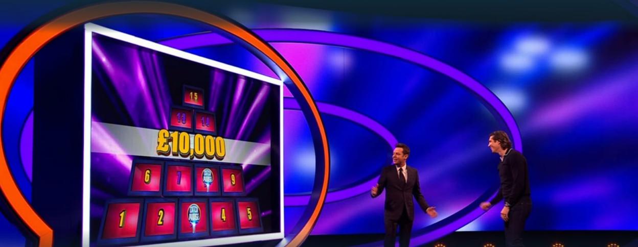 Two men on a game show set with a £10,000 prize puzzle.