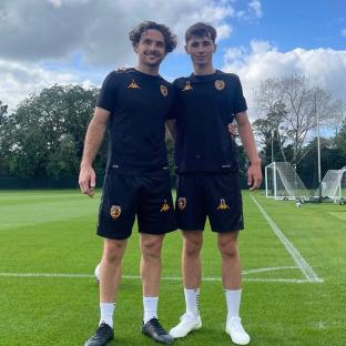 Lewie Coyle and Rocco Coyle, brothers, on a soccer field in Hull City uniforms.