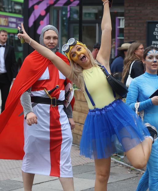 Three women in costume at a pub crawl.