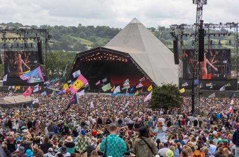 Large crowd at Glastonbury Festival in front of the Pyramid Stage.
